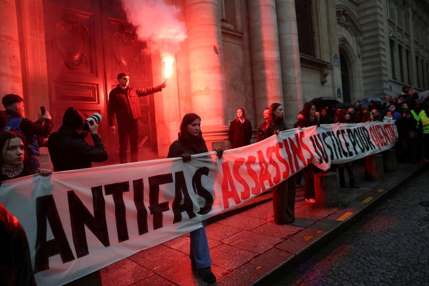 People gather to pay tribute to Quentin, an activist who died from injuries sustained during a beating on February 12 in Lyon, during a demonstration at the Place de la Sorbonne in Paris, France, February 15, 2026. The banner reads: "Antifas assassins, Justice for Quentin" REUTERS/Stephane Mahe