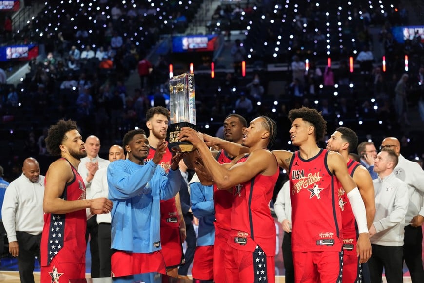 Feb 15, 2026; Inglewood, California, USA; Team USA Stars guard Cade Cunningham (2) of the Detroit Pistons, guard Anthony Edwards (5) of the Minnesota Timberwolves, center Chet Holmgren (7) of the Oklahoma City Thunder,  center Jalen Duren (0) of the Detroit Pistons, forward Scottie Barnes (4) of the Toronto Raptors and  forward Jalen Johnson (1) of the Atlanta Hawks, left to right, lift the trophy after defeating Team Stripes during the 75th NBA All Star Game at Intuit Dome. Mandatory Credit: Kirby Lee-Imagn Images