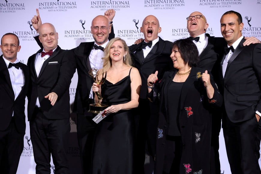 FILE PHOTO: Creator and Executive Producer Dana Eden and Executive Producer Shula Spiegel pose backstage with cast and crew members after winning an Emmy for "Tehran" in the category Drama at the 49th International Emmy Awards in New York City, New York, U.S., November 22, 2021. REUTERS/Caitlin Ochs/File Photo