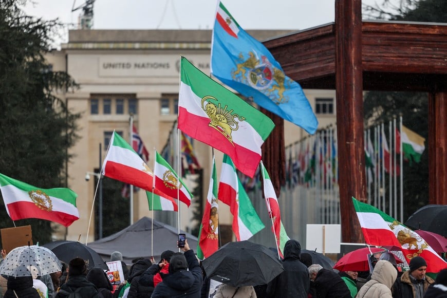 People wave "Lion and Sun" pre-Iranian Revolution national flags as they gather near the United Nations office, as the second round of nuclear talks between U.S. and Iran takes place, in Geneva, Switzerland, February 17, 2026. REUTERS/Pierre Albouy