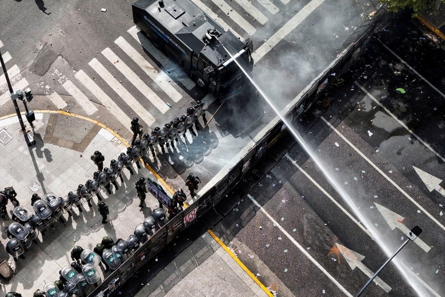 A drone view shows riot police using a water cannon during clashes with union members (not pictured) protesting outside the National Congress as members of Argentina's Senate discuss labor reforms proposed by President Javier Milei's libertarian government to attract investment and revive growth, while labor groups say it would roll back workers' right, in Buenos Aires, Argentina February 11, 2026. REUTERS/Martin Cossarini