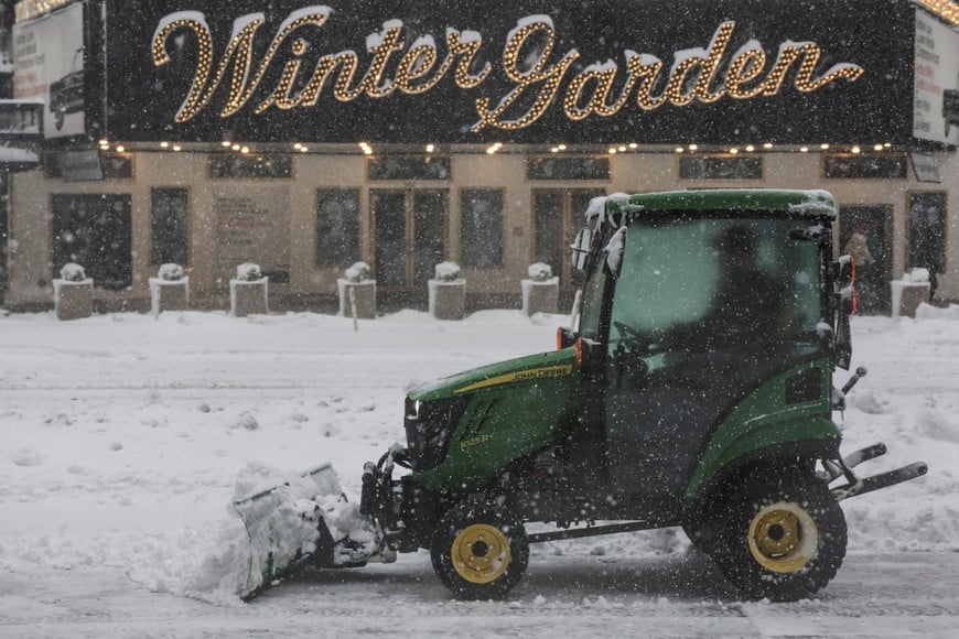 A worker clears snow on a street as snow falls during a winter storm in New York City, U.S., February 23, 2026. REUTERS/Jeenah Moon