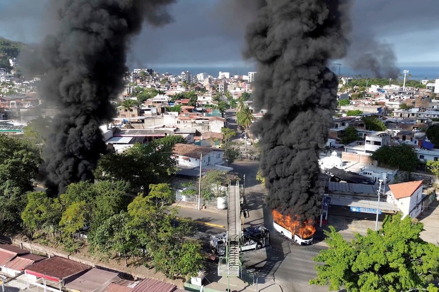 Smoke billows from burning vehicles amid a wave of violence, with torched vehicles and gunmen blocking highways in more than half a dozen states, following a military operation in which a government source said Mexican drug lord Nemesio Oseguera, known as "El Mencho," was killed, in Puerto Vallarta, Jalisco, Mexico, February 22, 2026, in this screen grab obtained from a social media video. @morelifediares via Instagram/Youtube/via REUTERS  THIS IMAGE HAS BEEN SUPPLIED BY A THIRD PARTY. MANDATORY CREDIT. NO RESALES. NO ARCHIVES. TPX IMAGES OF THE DAY

Verification:
Reuters confirmed the location as Puerto Vallarta by the road layout, trees, buildings and businesses logos which matched file and satellite imagery. The shape of the mountains matched topography mapping. The date when the videos were filmed was verified by original file metadata.