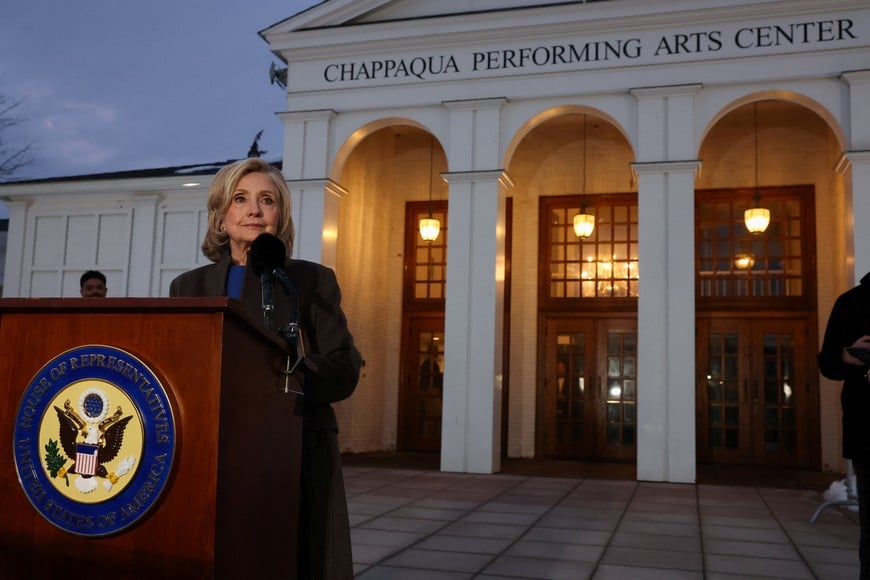 Former U.S. Secretary of State Hillary Clinton speaks to the members of the media outside the Chappaqua Performing Arts Center, on the day she appears for a deposition in the House Oversight Committee investigation of late financier and convicted sex offender Jeffrey Epstein, in Chappaqua, New York, U.S., February 26, 2026.  REUTERS/Shannon Stapleton