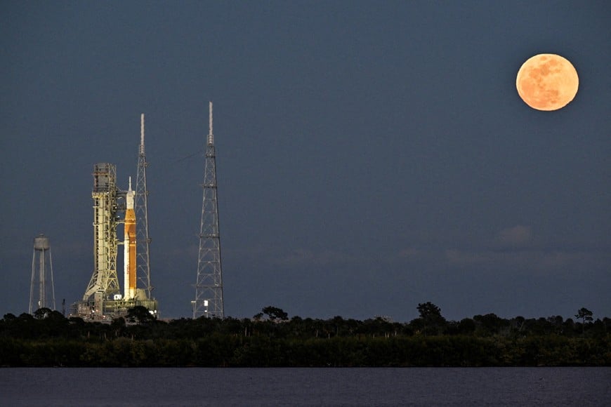 A full moon rises near the Space Launch System (SLS), with the Orion crew capsule, at launch complex 39B as preparations continue for the Artemis II mission to the Moon at Kennedy Space Center in Cape Canaveral, Florida, U.S., February 1, 2026. REUTERS/Steve Nesius     TPX IMAGES OF THE DAY