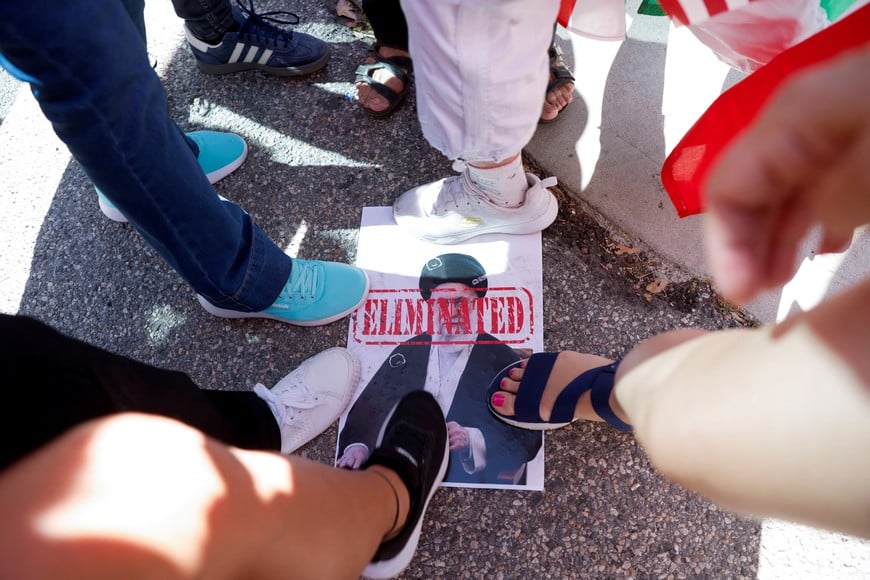 People step on a picture of Iran's Supreme Leader Ayatollah Ali Khamenei during a rally against Iran's ruling establishment in Los Angeles, California, U.S. February 28, 2026.  REUTERS/Jill Connelly