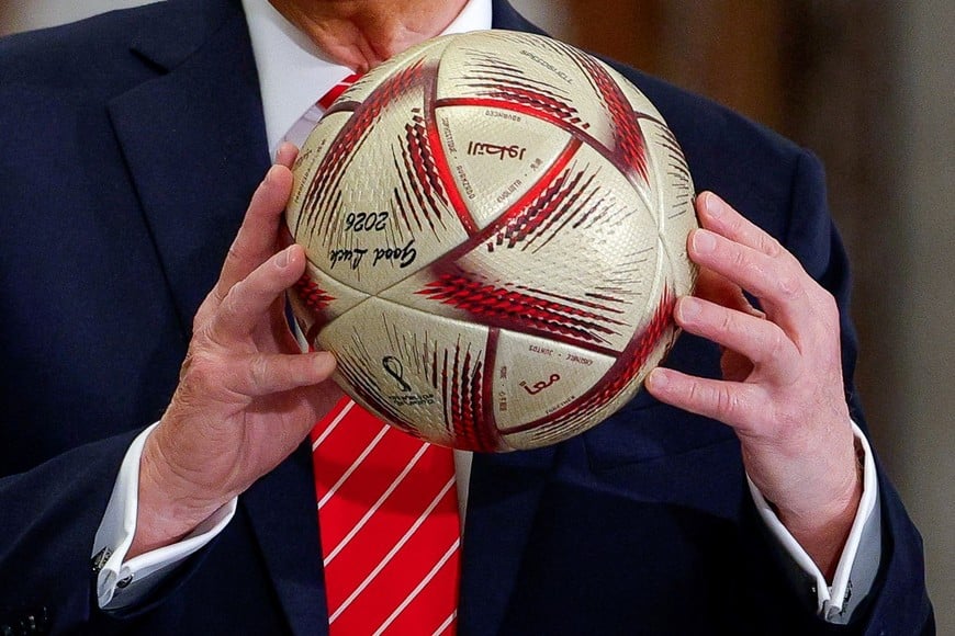 U.S. President Donald Trump holds a soccer ball as he attends an event with Qatar's Emir Tamim bin Hamad Al Thani (not pictured) and FIFA President Gianni Infantino (not pictured) at Lusail Palace in Lusail, Qatar, May 14, 2025. REUTERS/Brian Snyder