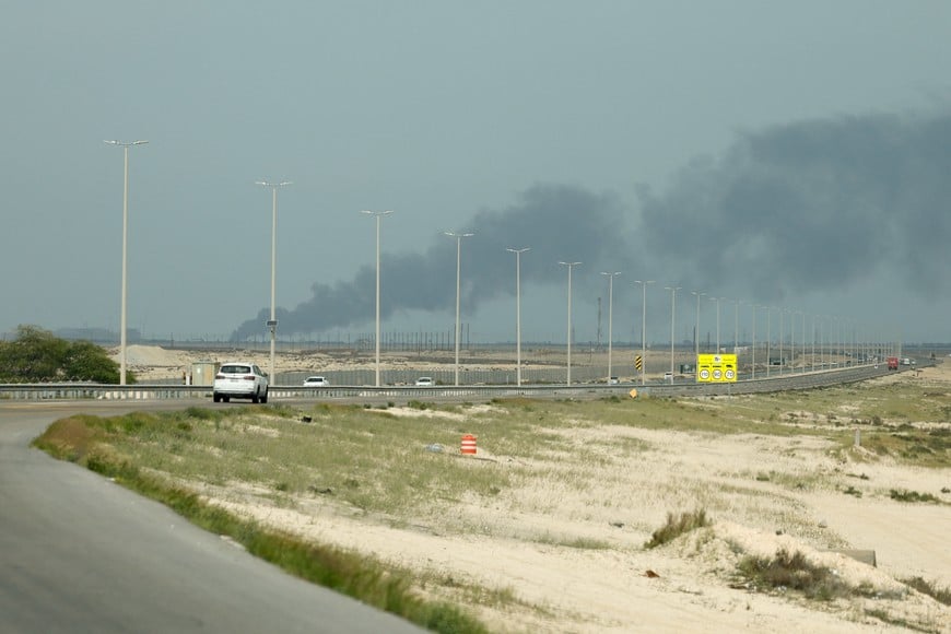 Vehicles move along a road as smoke billows from Saudi Aramco's Ras Tanura oil refinery after a reported Iranian drone strike, amid the U.S.-Israel conflict with Iran, in Ras Tanura, Saudi Arabia, March 2, 2026. REUTERS/Stringer