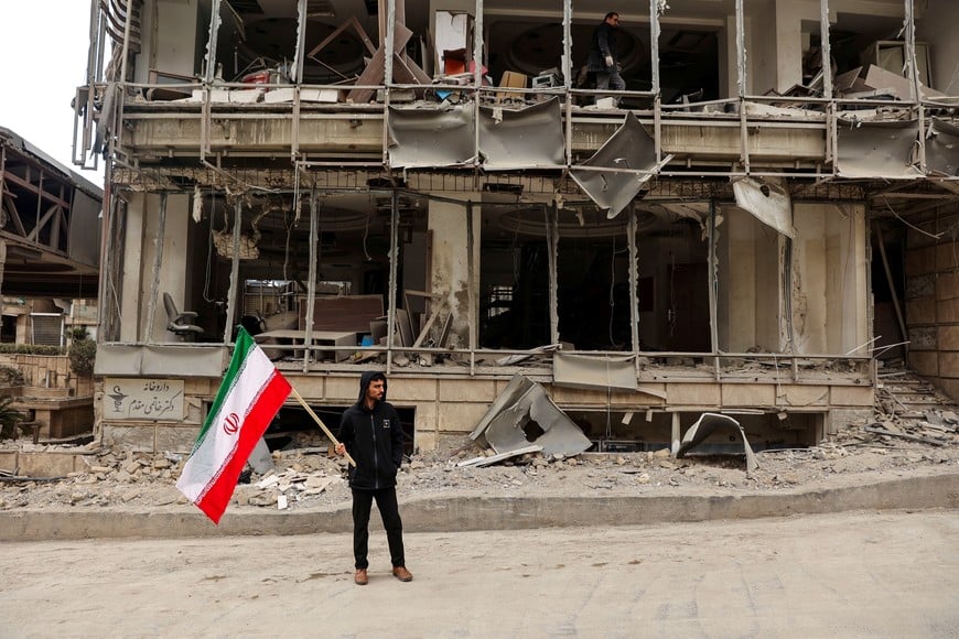 A man holds an Iranian flag following an Israeli and the U.S. strike on Gandhi Hotel Hospital, amid the U.S.-Israel conflict with Iran, in Tehran, Iran, March 2, 2026. Majid Asgaripour/WANA (West Asia News Agency) via REUTERS ATTENTION EDITORS - THIS PICTURE WAS PROVIDED BY A THIRD PARTY.