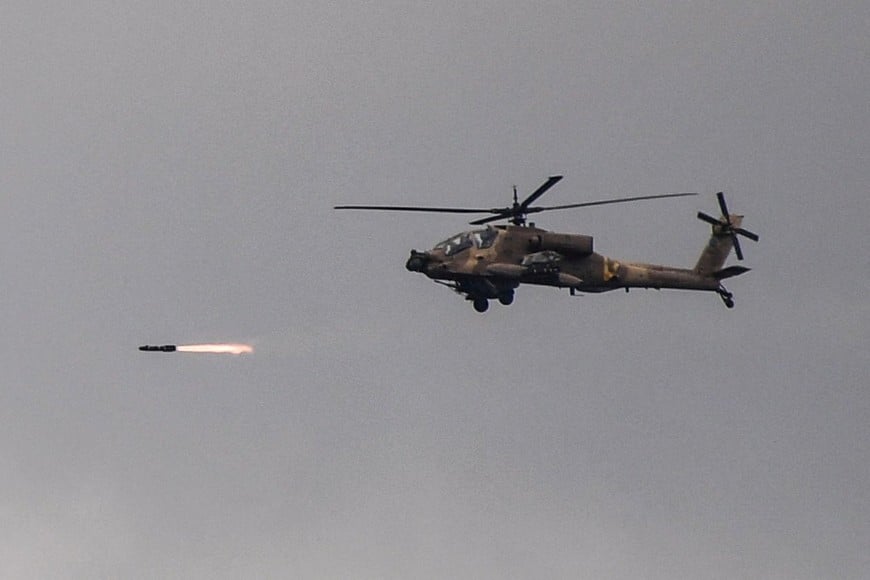 An Israeli Apache helicopter fires towards Lebanon as it flies above the Israel-Lebanon border, amid escalation between Iran-backed Hezbollah and Israel, and amid the U.S.-Israeli conflict with Iran, as seen from northern Israel, March 4, 2026. REUTERS/Gil Eliyahu ISRAEL OUT. NO COMMERCIAL OR EDITORIAL SALES IN ISRAEL TPX IMAGES OF THE DAY