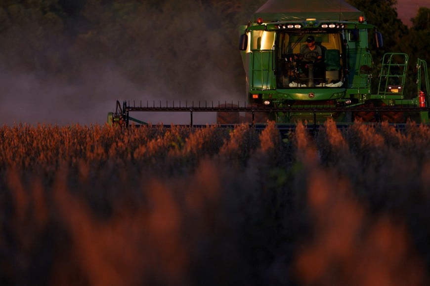 FILE PHOTO: A farm worker operates a combine harvester during the soybean harvest season in Brazil's southernmost state, on a farm in Nao Me Toque, Rio Grande do Sul state, Brazil, April 4, 2025. REUTERS/Diego Vara/File Photo
