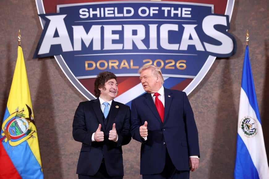 U.S. President Donald Trump and Argentina's President Javier Milei gesture as they attend the "Shield of the Americas" Summit in Miami, Florida, U.S., March 7, 2026. REUTERS/Kevin Lamarque