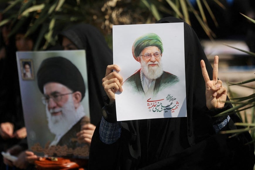 FILE PHOTO: A woman gestures while holding an image of Iran's late Supreme Leader Ayatollah Ali Khamenei, on the day of an anti-Israeli and U.S. rally, amid the U.S.-Israeli conflict with Iran, in Tehran, Iran, March 6, 2026. Majid Asgaripour/WANA (West Asia News Agency) via REUTERS ATTENTION EDITORS - THIS PICTURE WAS PROVIDED BY A THIRD PARTY/File Photo
