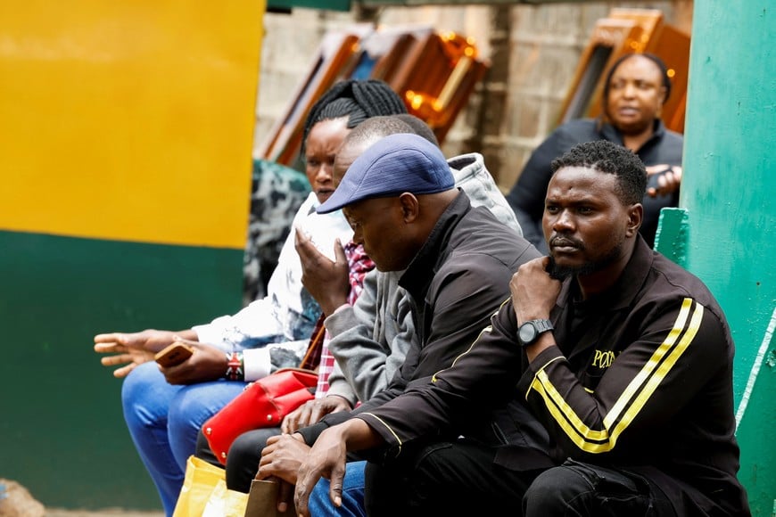 People sit as they wait to identify the body of their kins who died from floods after heavy rainfall, at the Nairobi Funeral Home in Nairobi, Kenya, March 9, 2026. REUTERS/Monicah Mwangi