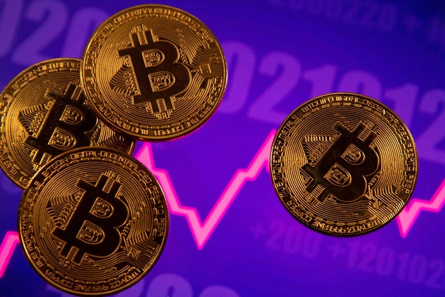 FILE PHOTO: A representation of virtual currency Bitcoin is seen in front of a stock graph in this illustration taken March 15, 2021. REUTERS/Dado Ruvic/Illustration//File Photo