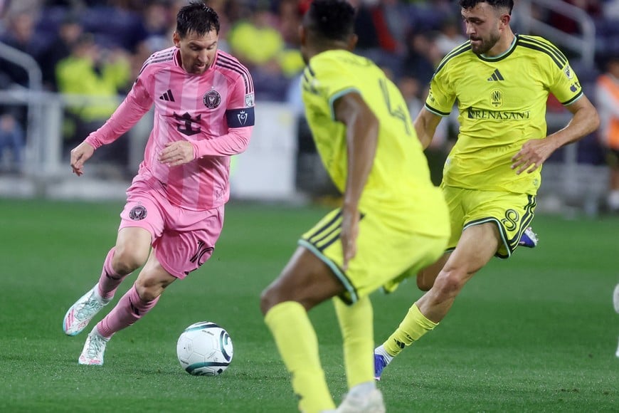 Mar 11, 2026; Nashville, Tennessee, USA; Inter Miami CF forward  Lionel Messi (10) attacks as Nashville SC midfielder Patrick Yazbek (8) defends during their 2026 Concacaf Champions Cup Round of 16 Leg 1 game at GEODIS Park. Mandatory Credit: Alan Poizner-Imagn Images
