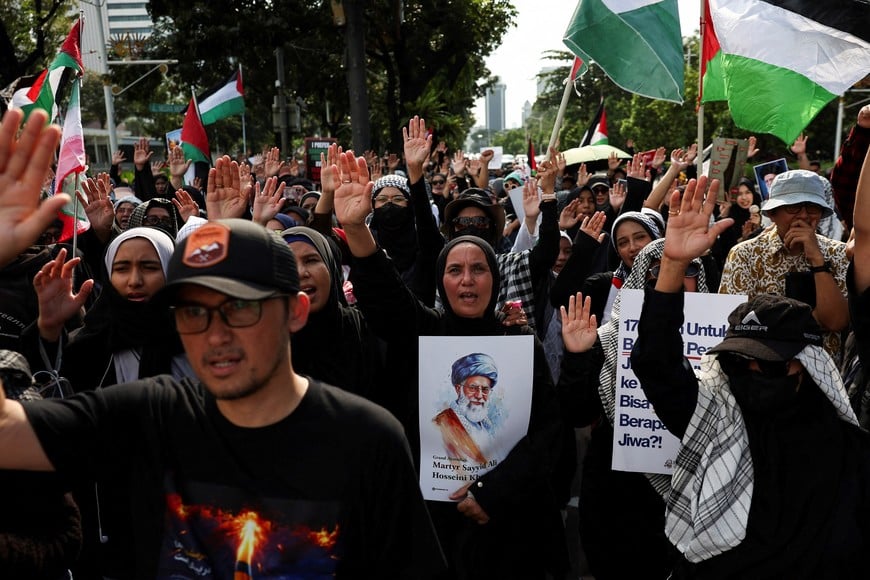 A protester holding a poster of Iran's late Supreme Leader Ayatollah Ali Khamenei, shouts slogans during a rally marking the annual al-Quds Day (Jerusalem Day) amid the U.S.-Israeli conflict with Iran, outside the U.S. Embassy in Jakarta, Indonesia, March 13, 2026. REUTERS/Willy Kurniawan