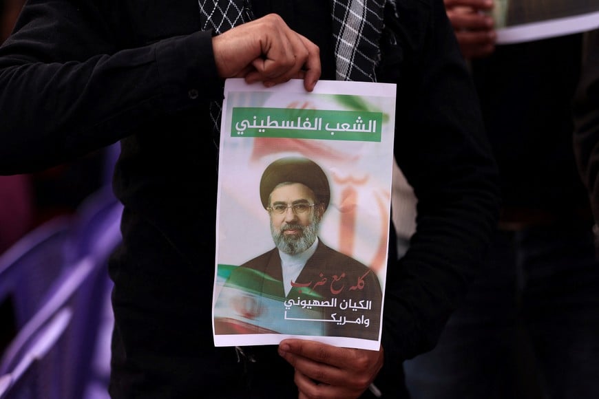 A Palestinian holds an image depicting Iran's new Supreme Leader Mojtaba Khamenei, as they take part in a rally on the al-Quds Day (Jerusalem Day), in Gaza City, March 13, 2026. REUTERS/Dawoud Abu Alkas