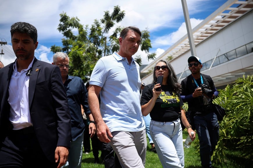 Senator Flavio Bolsonaro walks to attend a press conference outside a hospital, as his father, Brazil's former President Jair Bolsonaro is hospitalized, while serving a 27-year sentence for plotting a coup against his successor, President Luiz Inacio Lula da Silva, in Brasilia, Brazil, March 13, 2026. REUTERS/Adriano Machado
