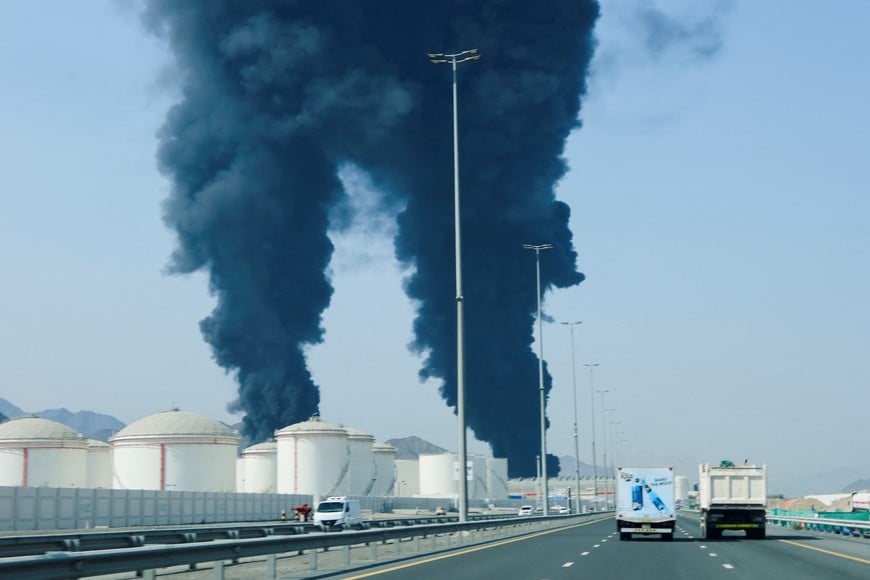 Smoke rises in the Fujairah oil industry zone, caused by debris after interception of a drone by air defenses, according to the Fujairah media office, amid the U.S.-Israel conflict with Iran, in Fujairah, United Arab Emirates, March 14, 2026. REUTERS/Staff