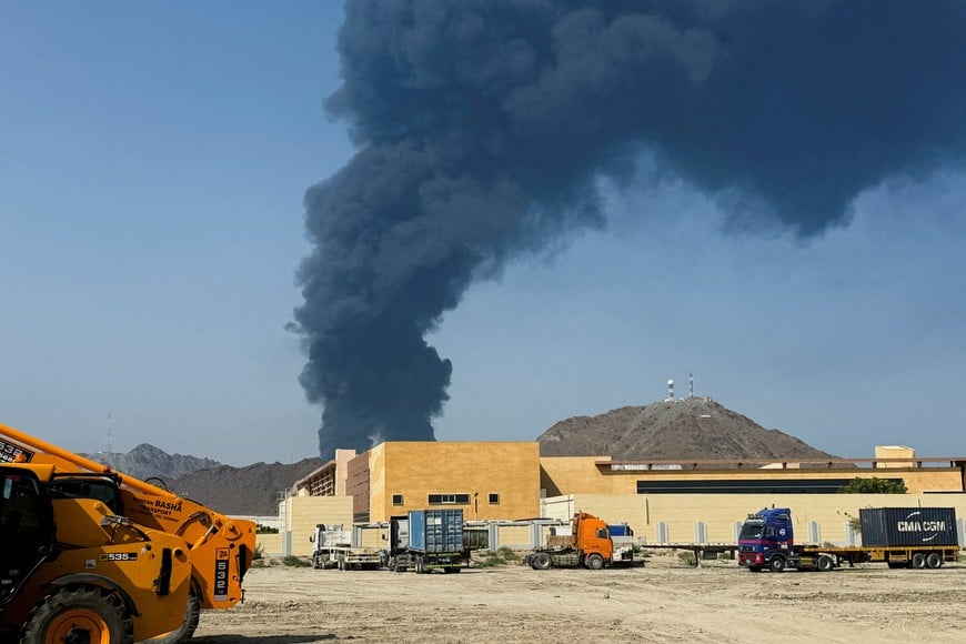 FILE PHOTO: Smoke rises in the Fujairah oil industry zone, caused by debris after interception of a drone by air defenses, according to the Fujairah media office, amid the U.S.-Israel conflict with Iran, in Fujairah, United Arab Emirates, March 14, 2026. Picture taken with a mobile phone. REUTERS/Staff/File Photo