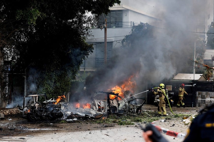 A firefighter works to put out a fire at an impact site, following missile barrages launched at Israel from Iran, amid the U.S.-Israel conflict with Iran, in central Israel March 15, 2026. REUTERS/Tomer Appelbaum    ISRAEL OUT. NO COMMERCIAL OR EDITORIAL SALES IN ISRAEL     TPX IMAGES OF THE DAY