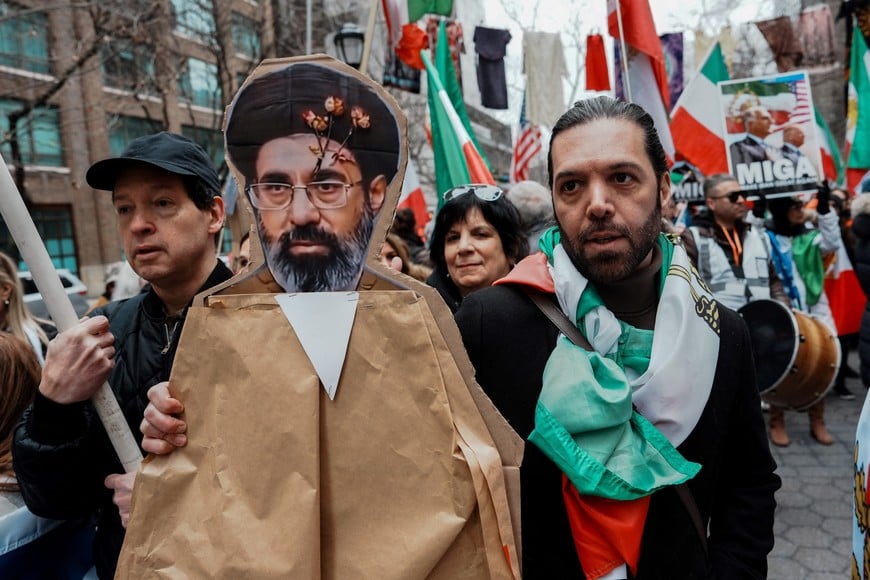 A protester holds an image of Iran's new Supreme Leader, Mojtaba Khamenei, during a demonstration against the Iranian government, in Manhattan, New York City, U.S., March 15, 2026. REUTERS/Adam Gray