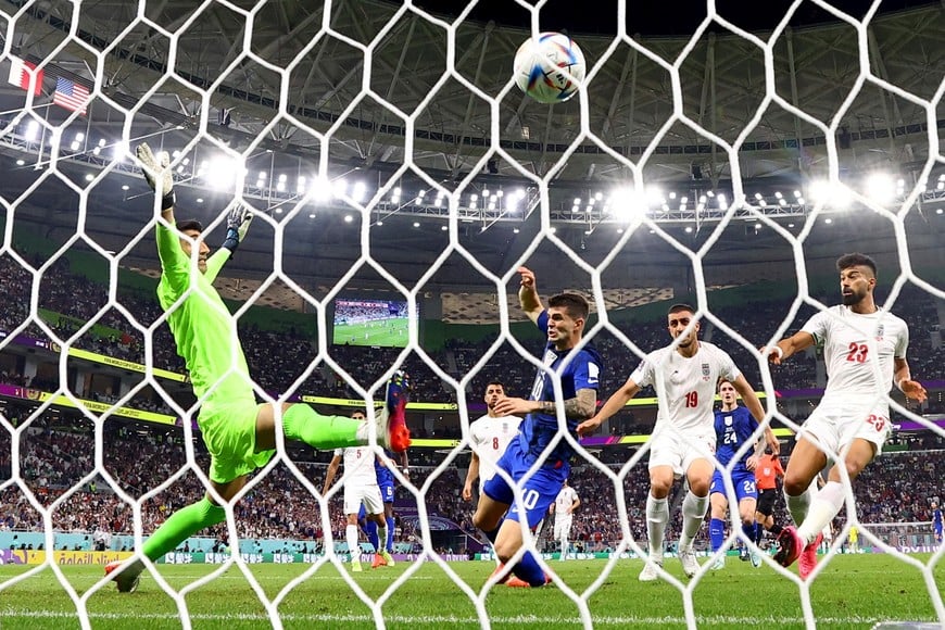 Soccer Football - FIFA World Cup Qatar 2022 - Group B - Iran v United States - Al Thumama Stadium, Doha, Qatar - November 29, 2022
Christian Pulisic of the U.S. scores their first goal past Iran's Alireza Beiranvand REUTERS/Kai Pfaffenbach     TPX IMAGES OF THE DAY