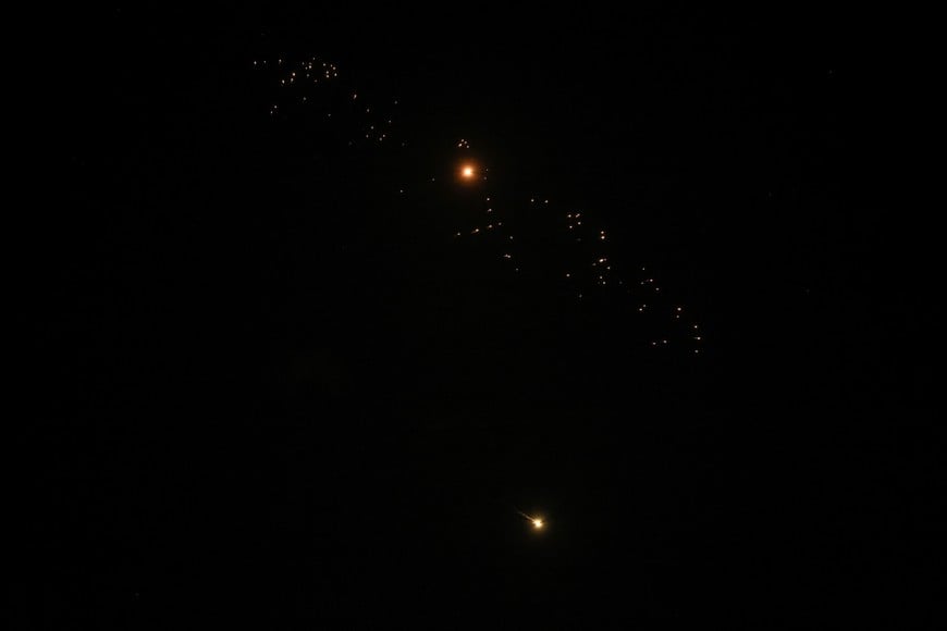 Streaks of fire and light cross the night sky as an Israeli interceptor strikes an Iranian missile amid the U.S.-Israeli conflict with Iran, over Tel Aviv, Israel, March 18, 2026. REUTERS/Tyrone Siu