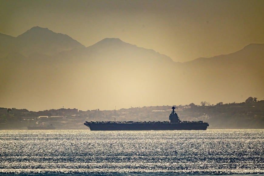 USS Gerald R. Ford aircraft carrier in the sea waters as seen from Gibraltar, with Northern Africa in the background, February 20, 2026 in this picture obtained from social media. @dparody/Instagram/via REUTERS  THIS IMAGE HAS BEEN SUPPLIED BY A THIRD PARTY. MANDATORY CREDIT. PICTURE PROCESSED AT SOURCE.

Verification:
-Ship design matched file imagery of USS Gerald R. Ford
-Other vessel in the photographs matched file imagery of US Destroyers, but the exact name of the ship could not be confirmed
-The shape of the mountains and road layout matched satellite imagery of the area
-Date confirmed by original files metadata