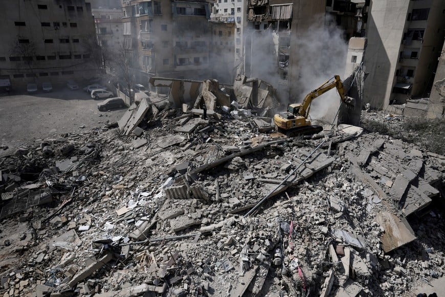 A man uses an excavator to clean debris at the site of an Israeli strike, following an escalation between Hezbollah and Israel amid the U.S.-Israeli conflict with Iran, Zuqaq al-Blat district in central Beirut, Lebanon, March 18, 2026. REUTERS/Khalil Ashawi