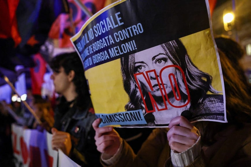A person holds a placard depicting Prime Minister Giorgia Meloni crossed with the word "No" as supporters of the "No" to the constitutional referendum on justice reform celebrate their victory in Rome, Italy, March 23, 2026. REUTERS/Matteo Minnella