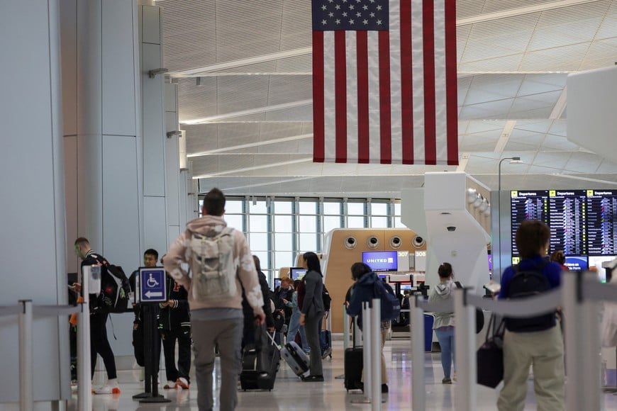 People walk at Newark Liberty International Airport, after hundreds of Immigration and Customs Enforcement agents were ordered to deploy to airports to help fill TSA staffing gaps, in Newark, New Jersey,  U.S., March 23, 2026. REUTERS/Jeenah Moon