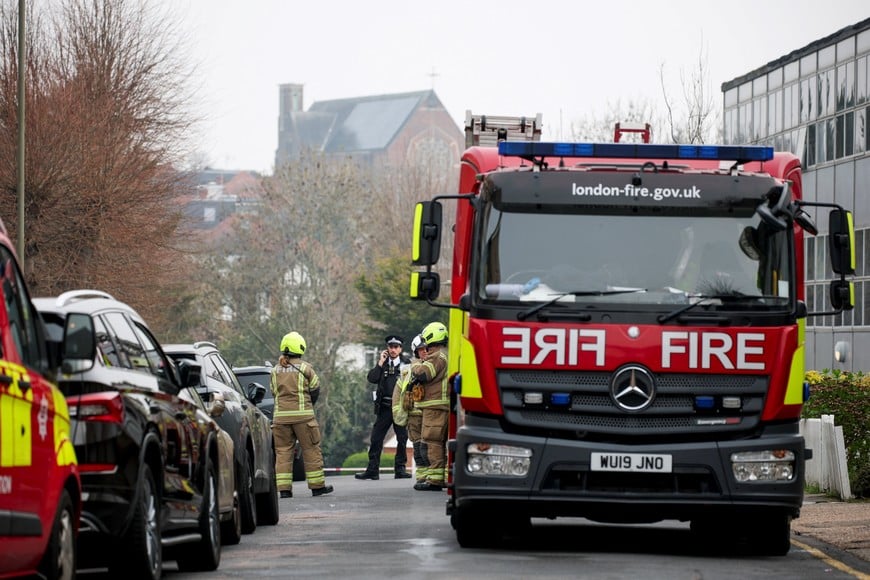 Emergency personnel stand next to a fire truck near the scene, after four ambulances belonging to Hatzola, a Jewish community organisation, were set on fire in an incident that the police say is being treated as an antisemitic hate crime, in northwest London, Britain, March 23, 2026. REUTERS/Isabel Infantes