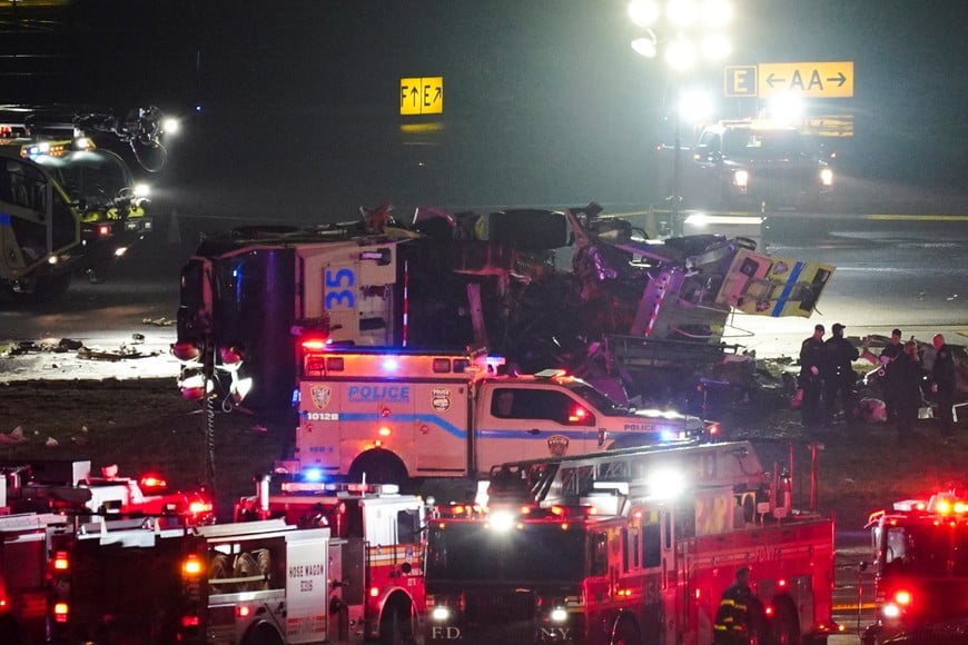 Emergency crews work around a ground vehicle following a collision between the vehicle and an Air Canada Express jet at New York's La Guardia Airport in Queens, New York, U.S. March 23, 2026.  REUTERS/Bing Guan