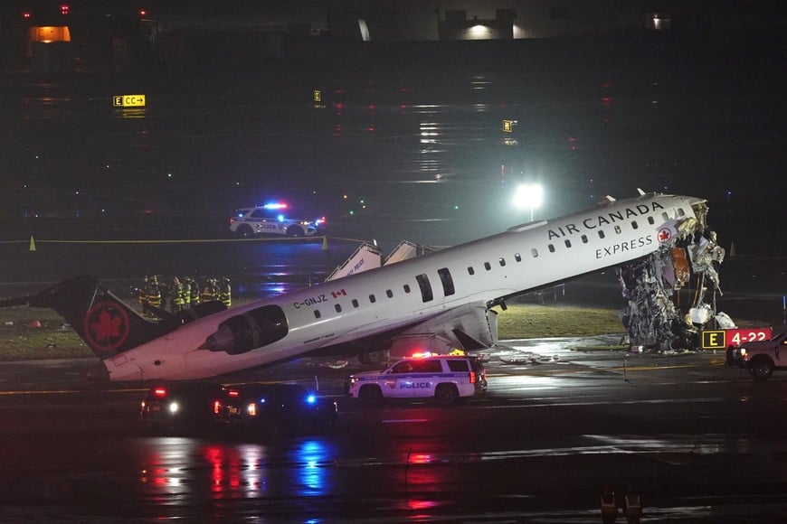 Emergency crews work around an Air Canada Express jet that had collided with a ground vehicle at New York's La Guardia Airport in Queens, New York, U.S. March 23, 2026.  REUTERS/Bing Guan     TPX IMAGES OF THE DAY