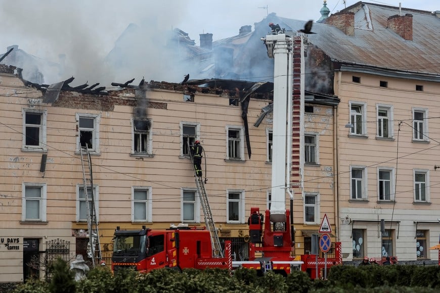Firefighters work at the site of a building hit by a Russian drone strike, amid Russia's attack on Ukraine, in the downtown of Lviv, Ukraine, March 24, 2026.  REUTERS/Roman Baluk     TPX IMAGES OF THE DAY