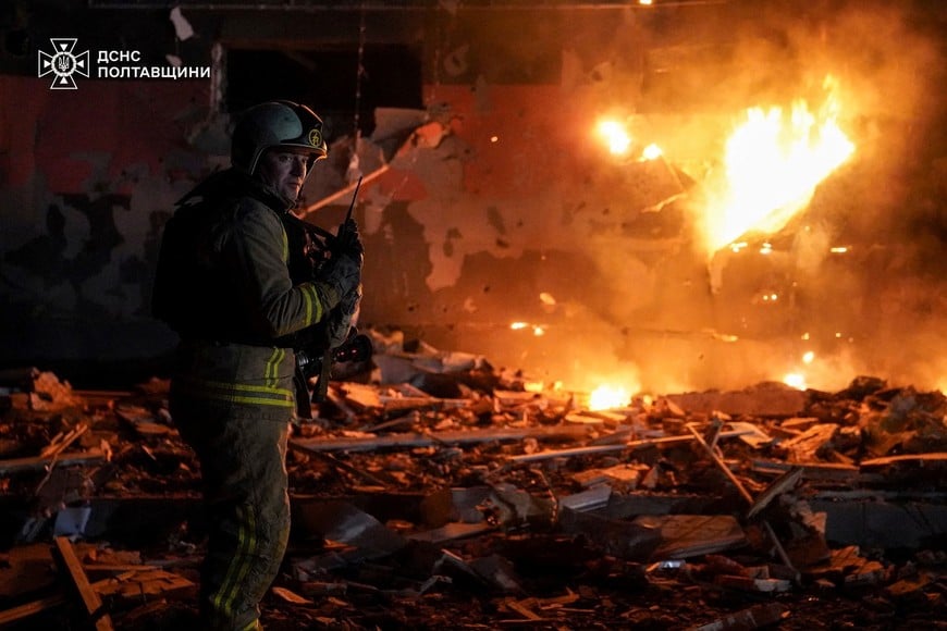 A firefighter works at the site of a building damaged during overnight Russian drone and missile strikes, amid Russia's attack on Ukraine, in Poltava, Ukraine, March 24, 2026. Press service of the State Emergency Service of Ukraine in Poltava region/Handout via REUTERS ATTENTION EDITORS - THIS IMAGE HAS BEEN SUPPLIED BY A THIRD PARTY. DO NOT OBSCURE LOGO.