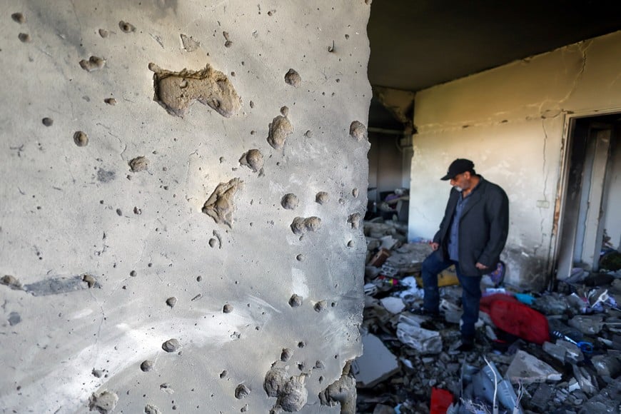 Abbas Qasem walks inside a house damaged by an Israeli strike, following an escalation between Hezbollah and Israel, amid the U.S.-Israeli conflict with Iran, in Beirut, Lebanon, March 24, 2026. REUTERS/Amr Abdallah Dalsh