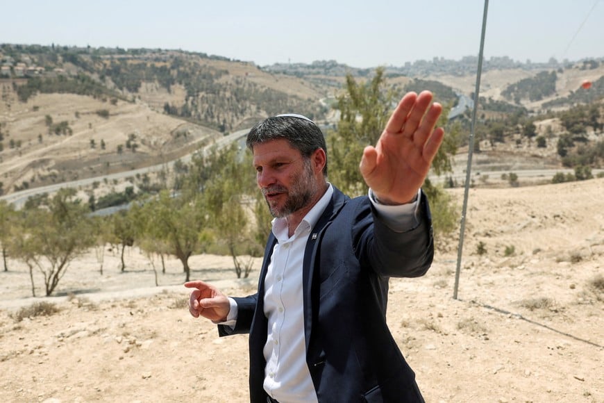 FILE PHOTO: Israeli Finance Minister Bezalel Smotrich gestures, on the day of a press conference regarding settlements expansion for the long-frozen E1 settlement, that would split East Jerusalem from the occupied West Bank, near the Israeli settlement of Maale Adumim in the Israeli-occupied West Bank, August 14, 2025. REUTERS/Ronen Zvulun/File Photo