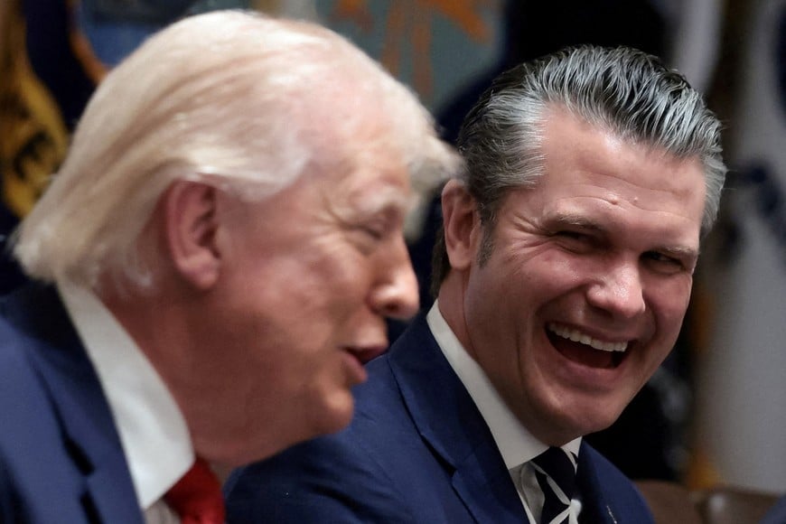 U.S. President Donald Trump and Defense Secretary Pete Hegseth react during a cabinet meeting at the White House in Washington, D.C., U.S., March 26, 2026. REUTERS/Evelyn Hockstein