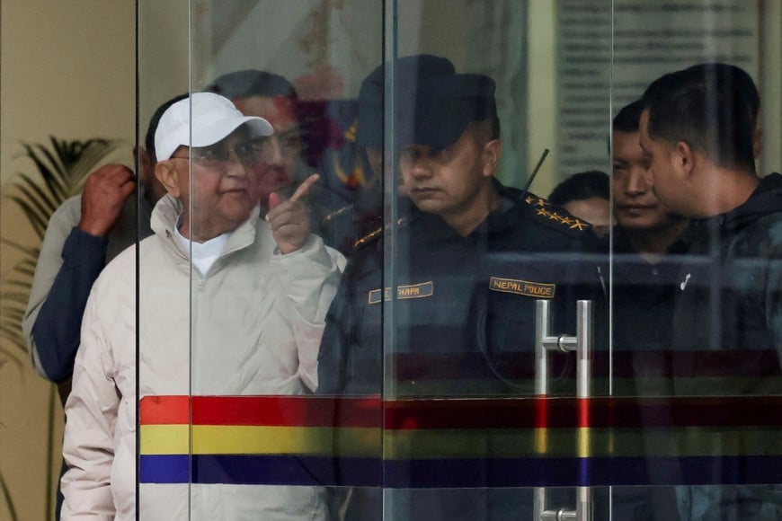 Former Nepal Prime Minister and Chairman of the Communist Party of Nepal (Unified Marxist–Leninist) K.P. Sharma Oli gestures while being taken to a hospital from the District Police Range after his detention by police, who are investigating whether he was negligent in preventing dozens of deaths during the Gen Z protests, in Kathmandu, Nepal, March 28, 2026. REUTERS/Navesh Chitrakar REFILE - CLARIFYING PARTY NAME