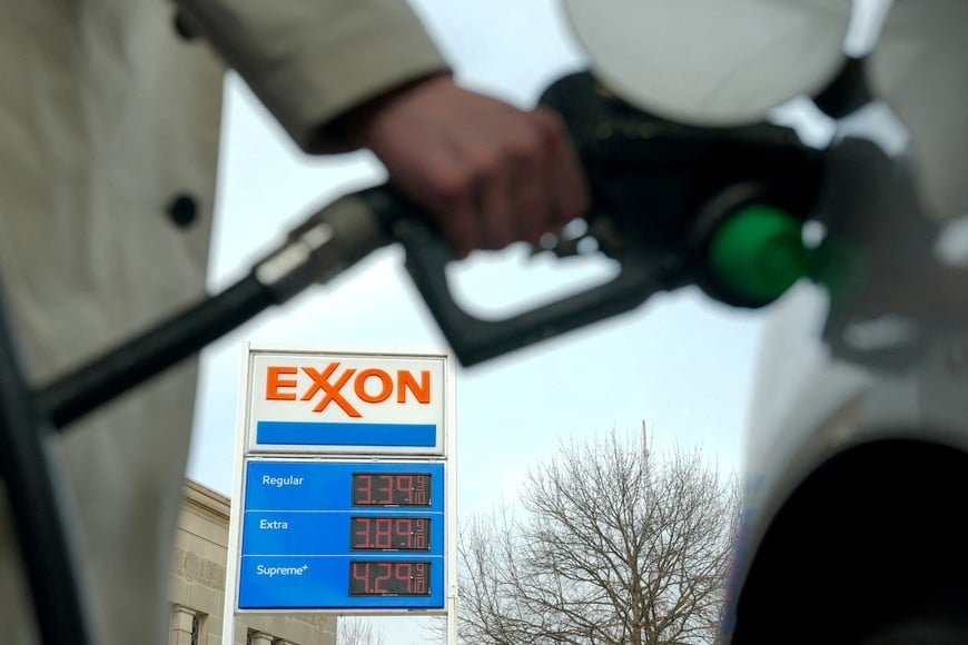 FILE PHOTO: A man pumps gas at an Exxon station as the price of oil and gas has surged amid the U.S.-Israeli conflict with Iran, in Washington, D.C., U.S., March 5, 2026. REUTERS/Ken Cedeno/File Photo