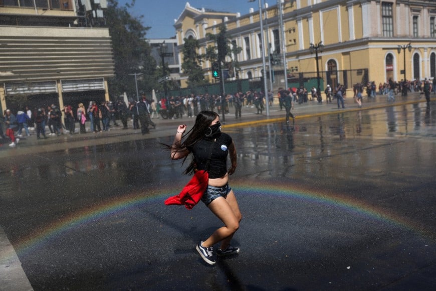 A demonstrator wearing a mask prepares to throw an object during a protest against the Chilean government's budget cuts to education, in Santiago, Chile, March 26, 2026. REUTERS/Pablo Sanhueza