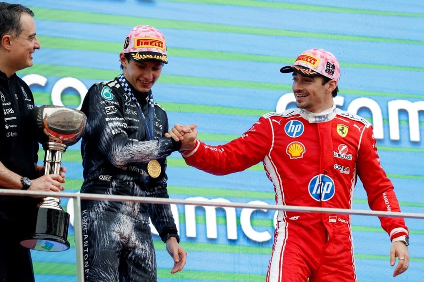 Formula One F1 - Japanese Grand Prix - Suzuka Circuit, Suzuka, Japan - March 29, 2026
Mercedes' Andrea Kimi Antonelli shakes hands with on the podium with third placed Ferrari's Charles Leclerc after winning the Japanese Grand Prix REUTERS/Kim Kyung-Hoon