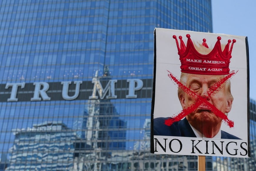 A person holds a sign with an image depicting U.S. President Donald Trump as demonstrators walk past the Trump Tower during a "No Kings" protest against the Trump administration's policies, in Chicago, Illinois, U.S., March 28, 2026. REUTERS/Jim Vondruska     TPX IMAGES OF THE DAY