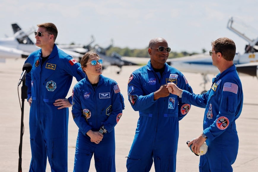 NASA astronauts Reid Wiseman and Victor Glover greet each other next to NASA astronaut Christina Koch and CSA (Canadian Space Agency) astronaut Jeremy Hansen, at Kennedy Space Centre, ahead of the Artemis II launch in Cape Canaveral, Florida, U.S., March 27, 2026.  REUTERS/Joe Skipper     TPX IMAGES OF THE DAY
