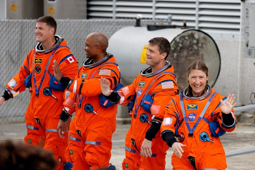 The crew of the Artemis II launch mission to fly by the moon, NASA astronauts Reid Wiseman, Victor Glover and Christina Koch and CSA (Canadian Space Agency) astronaut Jeremy Hansen, react in front of the astronaut van before heading to launch 39B at the Kennedy Space Center in Cape Canaveral, Florida, U.S. April 1, 2026.  REUTERS/Joe Skipper