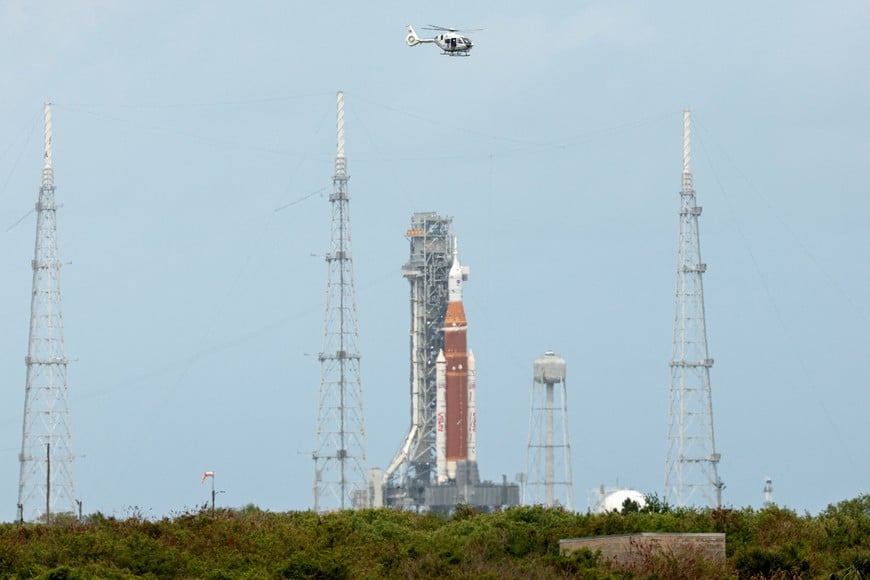 A helicopter flies past the Artemis II Space Launch System (SLS) rocket and Orion spacecraft at Launch Complex 39B ahead of the mission launch at the Kennedy Space Center in Cape Canaveral, Florida, U.S., April 1, 2026. REUTERS/Brendan McDermid