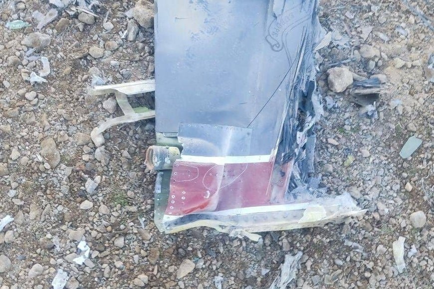 The Iranian state media said to show fragments of a downed U.S. jet in this picture said to be taken in central Iran and released on April 3, 2026. IRIB/Handout via REUTERS THIS IMAGE HAS BEEN SUPPLIED BY A THIRD PARTY. IRAN OUT. NO COMMERCIAL OR EDITORIAL SALES IN IRAN. NO USE BBC PERSIAN. NO USE VOA PERSIAN. NO USE MANOTO. NO USE IRAN INTERNATIONAL. NO USE RADIO FARDA. REFILE - CORRECTING FROM "JETS" TO "JET"
VERIFICATION:
-Reuters was not able to confirm the location or date when the photos were taken.
-The red stripe seen on the tail fin of the plane in the photos is consistent with the tail section of a F-15E Strike Eagle seen in file photos.